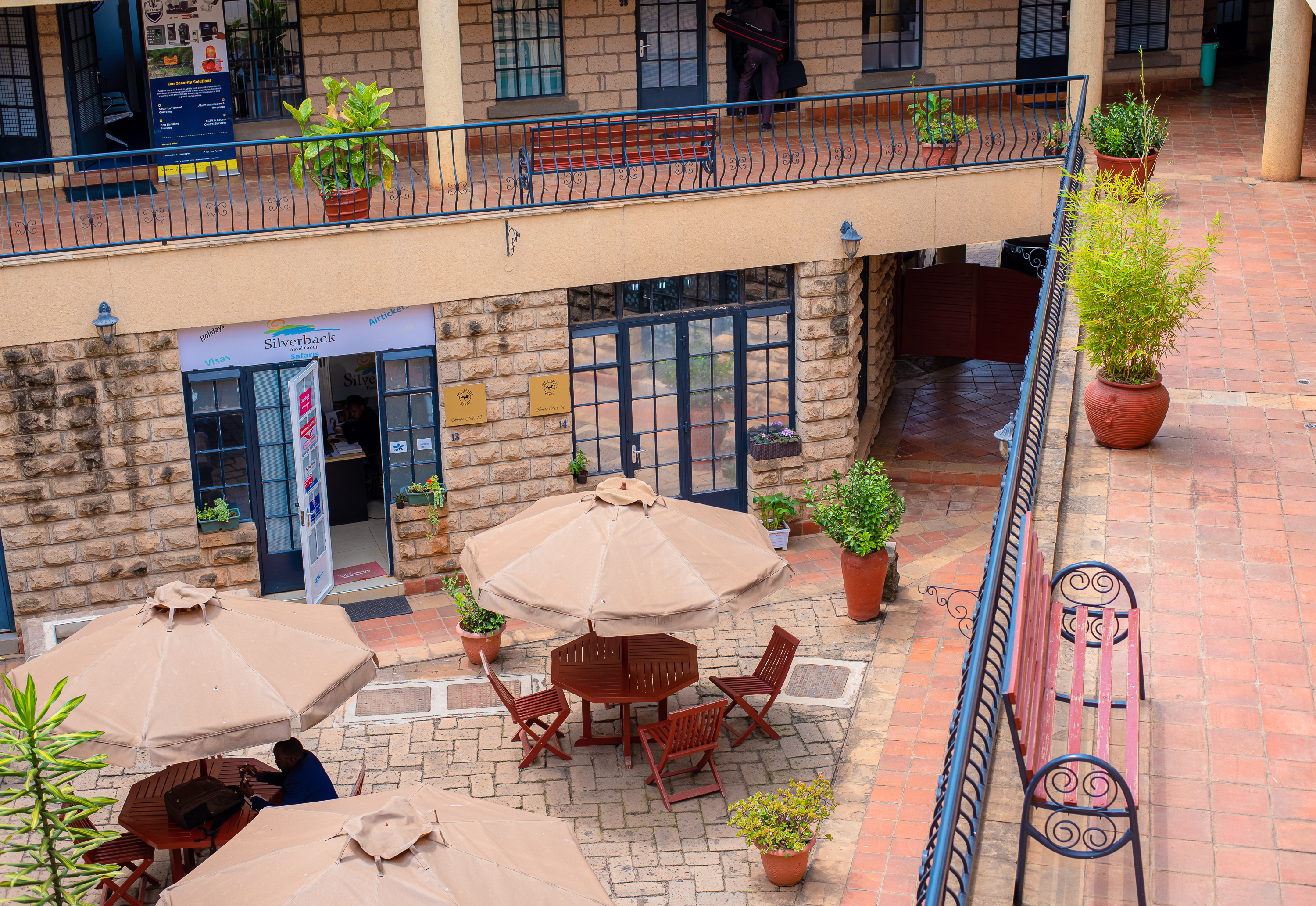 Peaceful courtyard seating with natural shade and ambient lighting